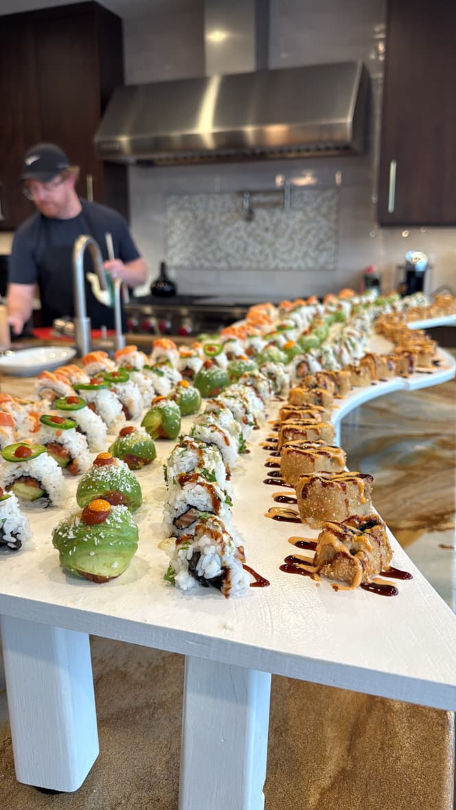 Sushi River table with guests enjoying flowing rolls